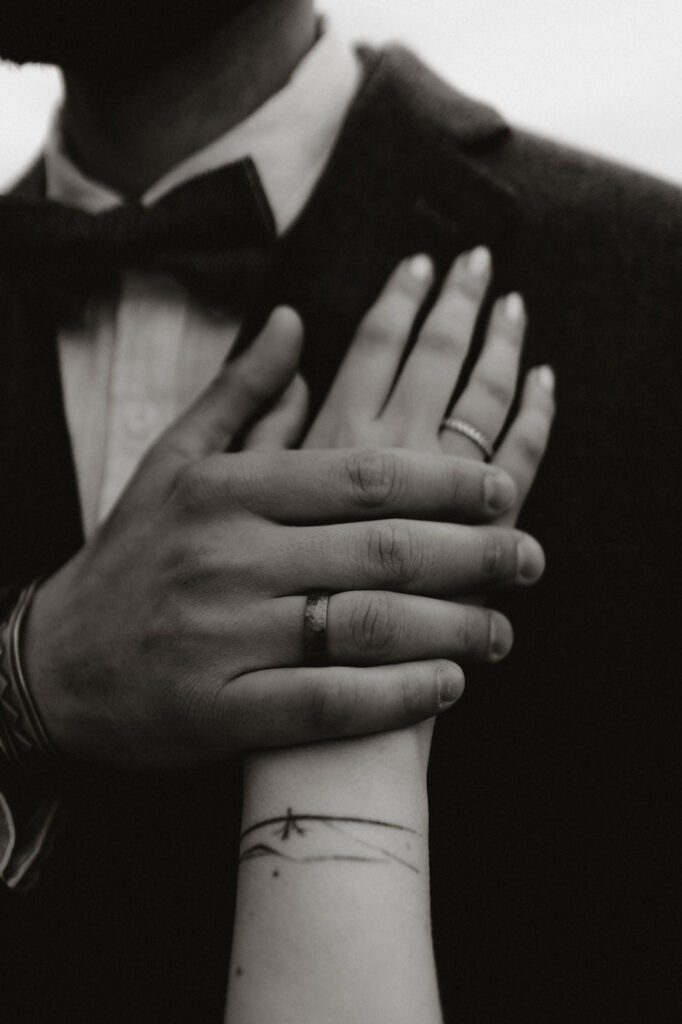 bride puts hand on grooms chest during honeymoon photos.