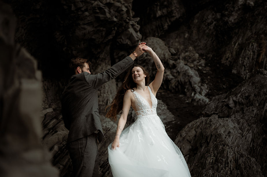 groom twirls bride during photo shoot with iceland wedding photographer.