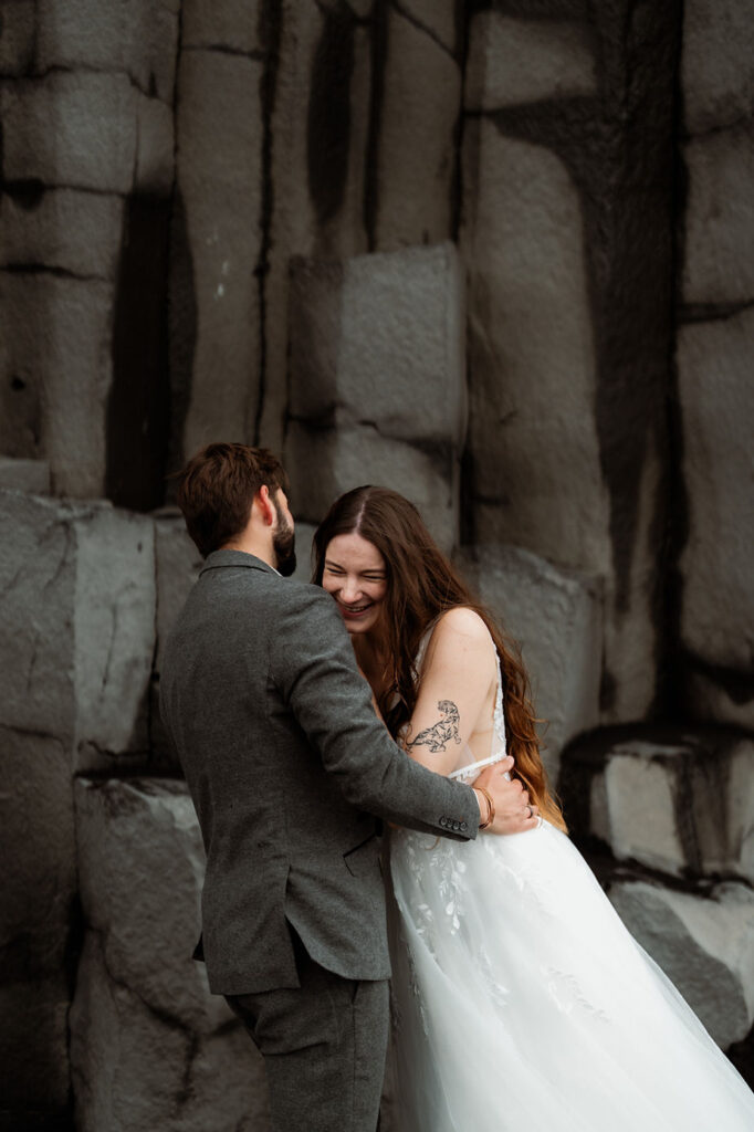bride and groom hug and laugh dring photo shoot with iceland elopement photographer.