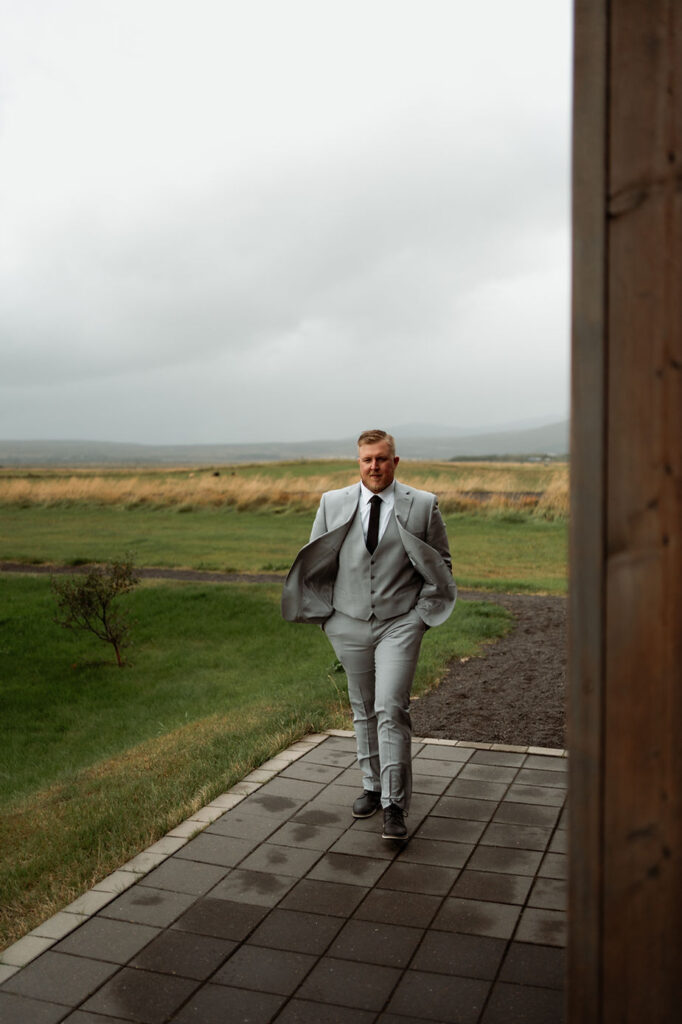 groom walks to cottage in iceland.
