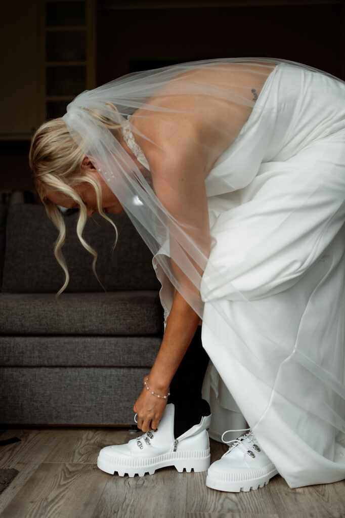 bride puts wedding boots on.