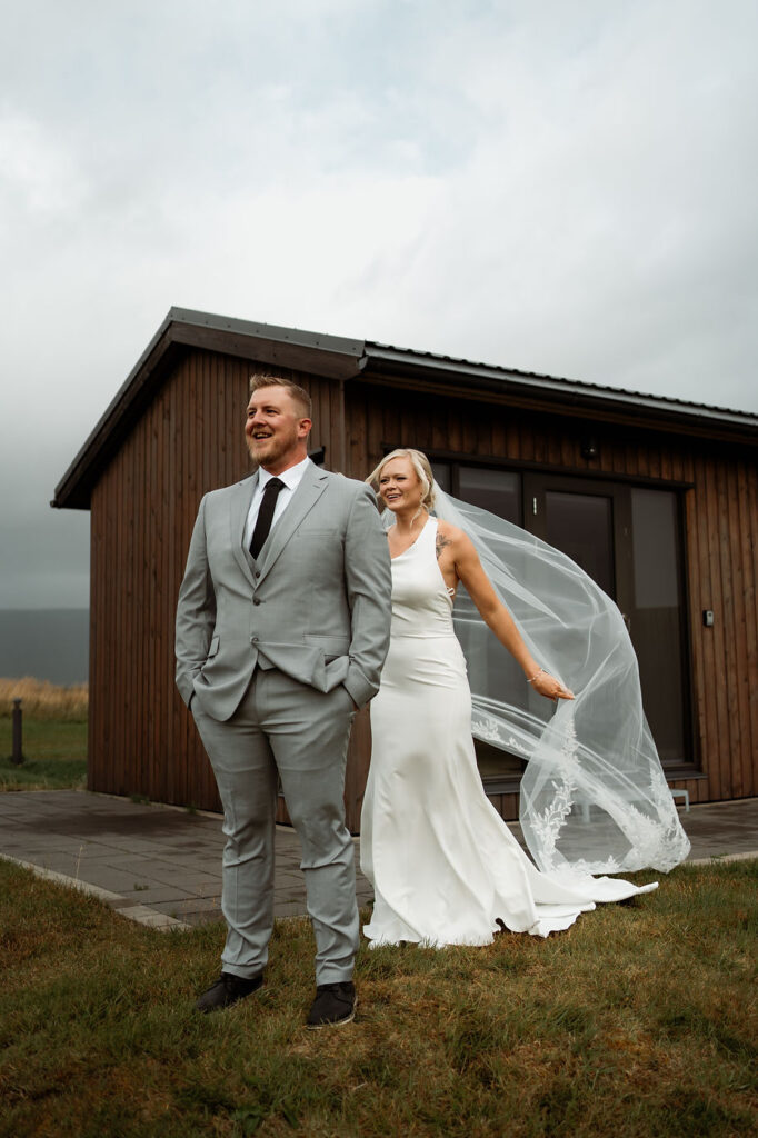 bride walks up behind groom for first look.