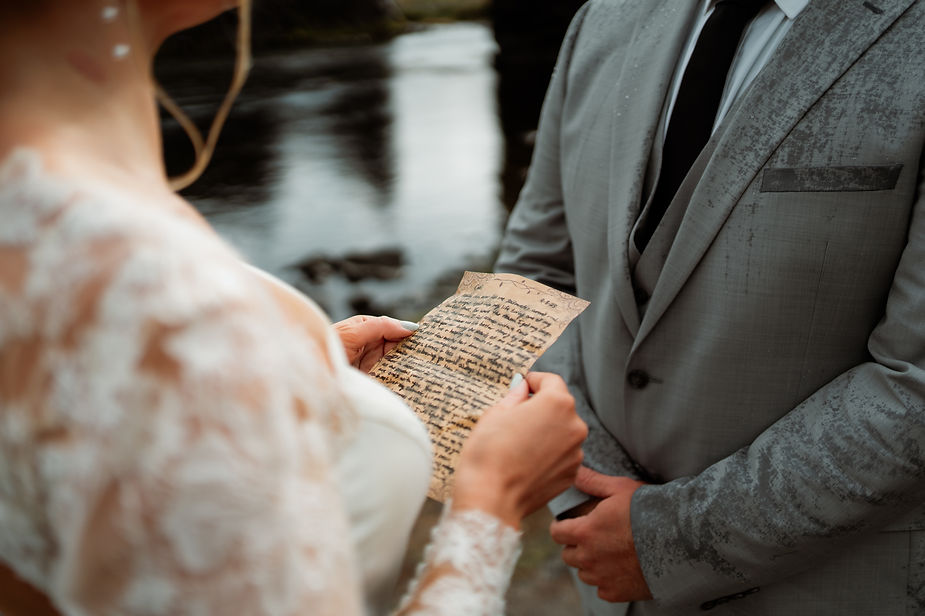 bride and groom read vows during their iceland wedding.