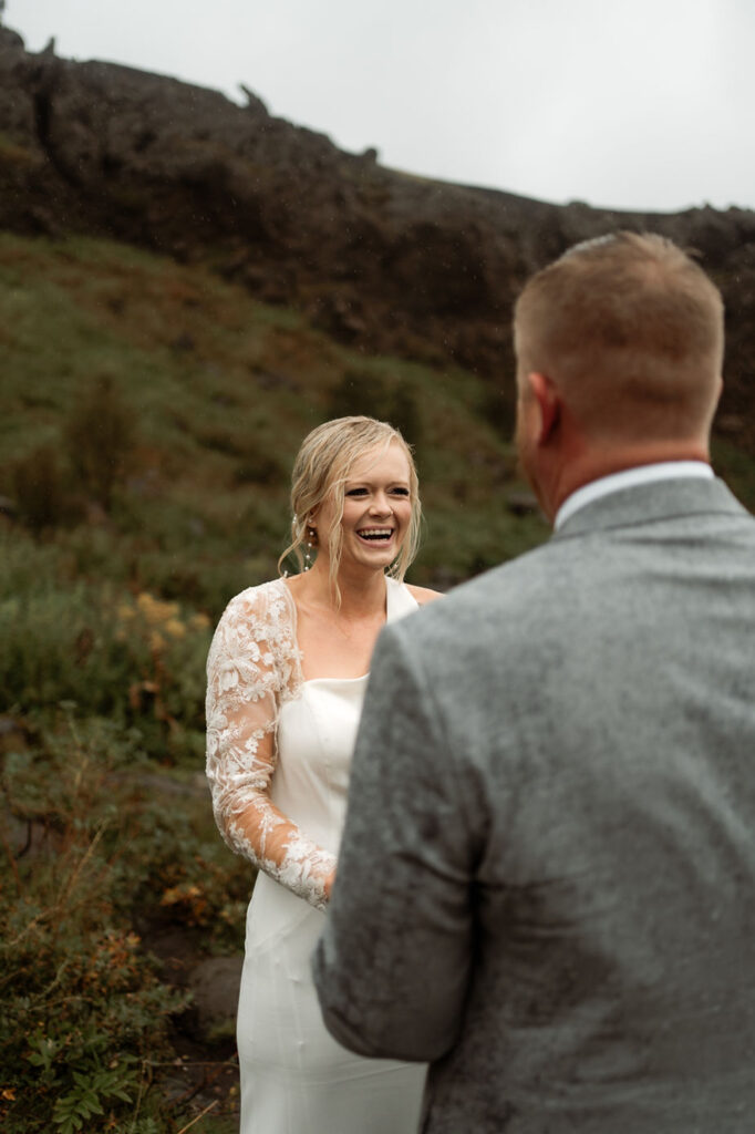 bride and groom read vows during adventure wedding in iceland.