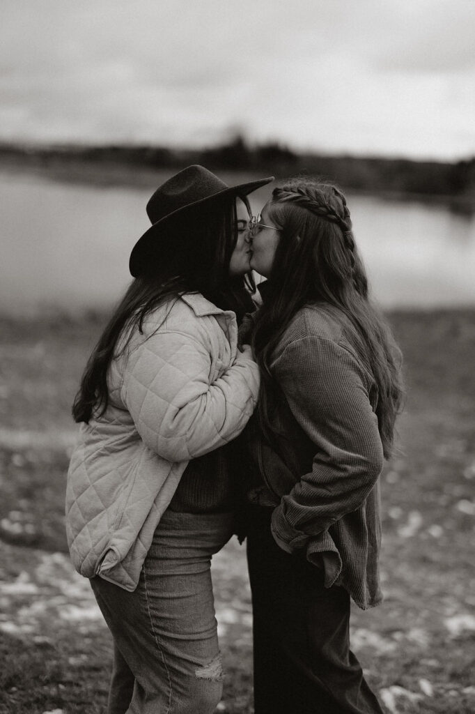 lgbtq+ couple kiss during their iceland proposal.