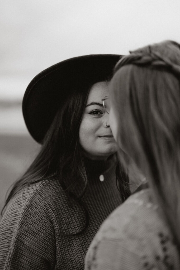 lgbtq+ couple pose for iceland photogrpaher during engagement photos.