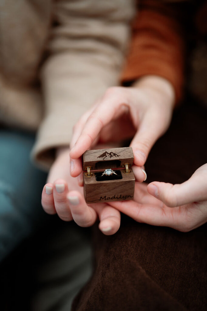 close up image of wooden engagement ring box and ring inside, during iceland proposal.