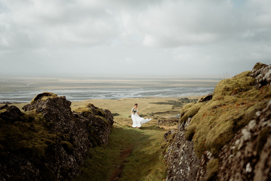 bride walks to groom in iceland valley for first look.
