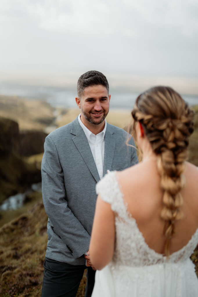 groom smiles at bride during iceland elopement photos.