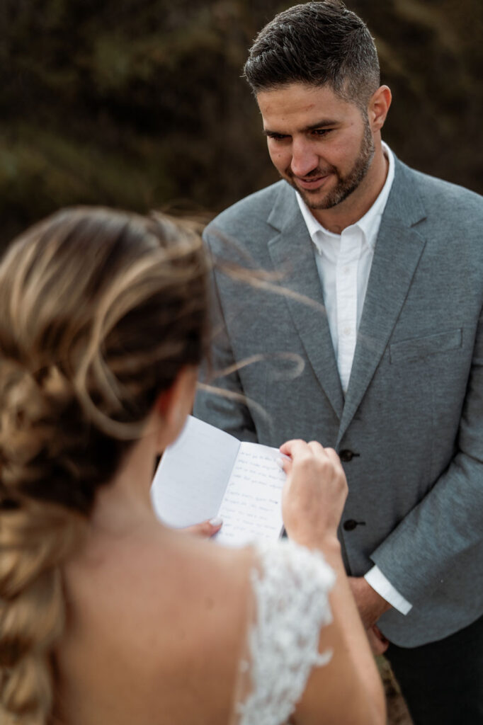 bride reads wedding vows to groom during iceland elopement.