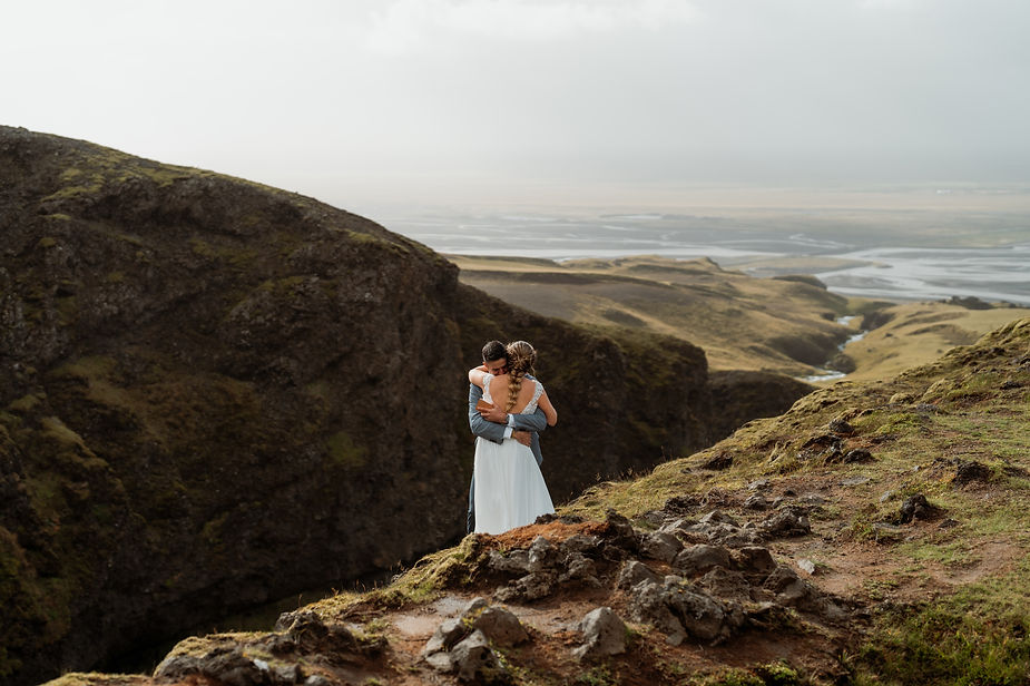 bride and groom ug on elopement day overlooking iceland valley.