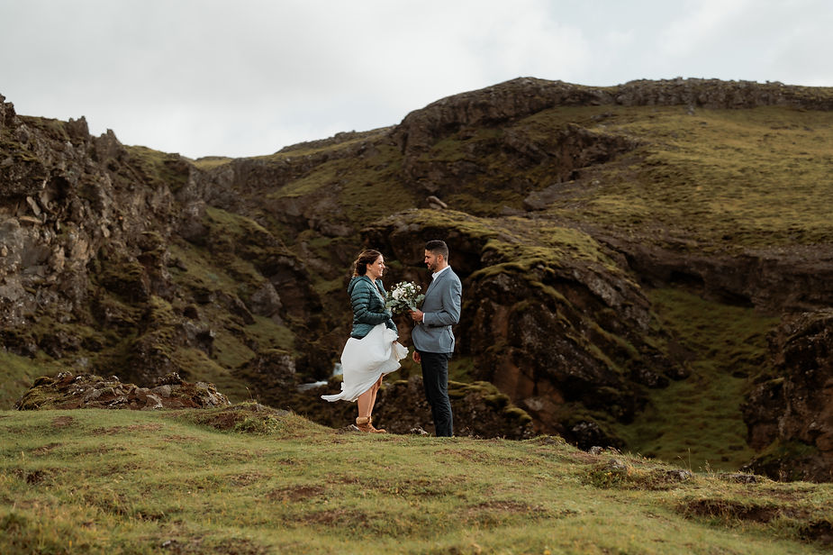 bride and groom pose for iceland elopement photographer in iceland valley.