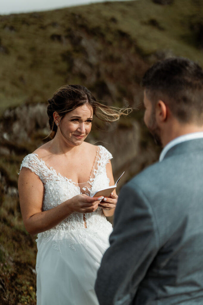 bride reads wedding vows to groom during iceland wedding.