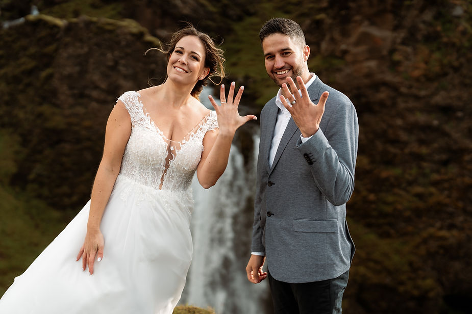 bride and groom pose with wedding rings for iceland elopement photographer.