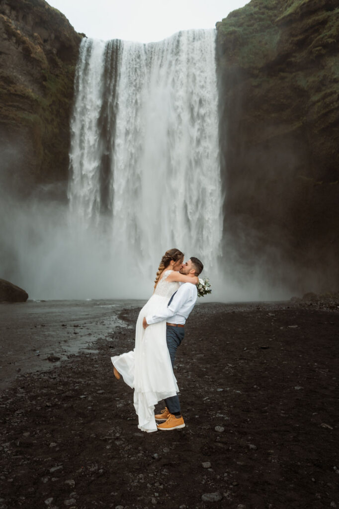 groom picks up bride and kisses her during iceland adventure elopement.